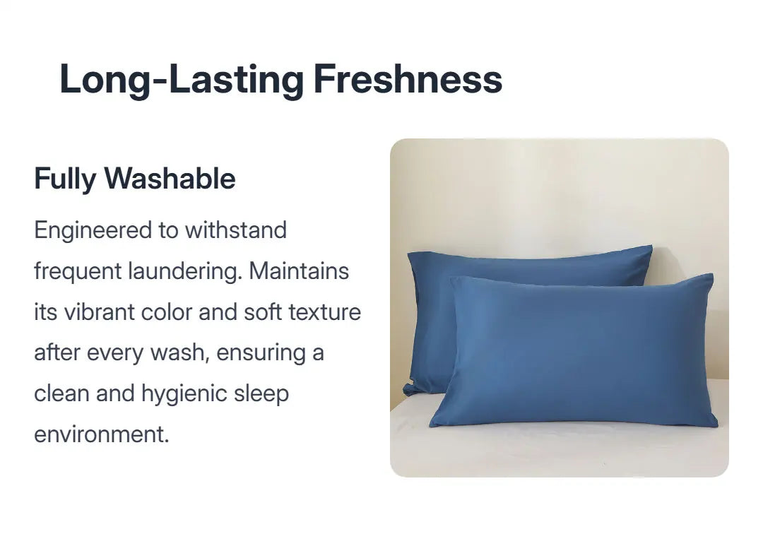 A set of solid blue pillows resting on a white bed with a light background.