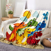 A colorful dinosaur cartoon throw blanket featuring various dinosaurs and a sun design.