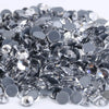 A pile of clear and black crystal AB flatback rhinestones for crafts and decor.