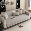 A light gray sofa cushion with a textured fabric is displayed on a modern living room floor.
