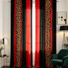 A set of two floor-length curtains featuring a black and orange leopard print fabric, displayed in a bright room.