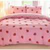 Pink duvet cover set with a strawberry print featuring pink and white accents.