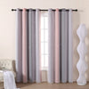 Grey and pink gradient star perforated curtains hanging in a window frame.