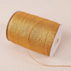 A roll of 10-meter gold and silver glitter satin ribbon is shown on a light background.