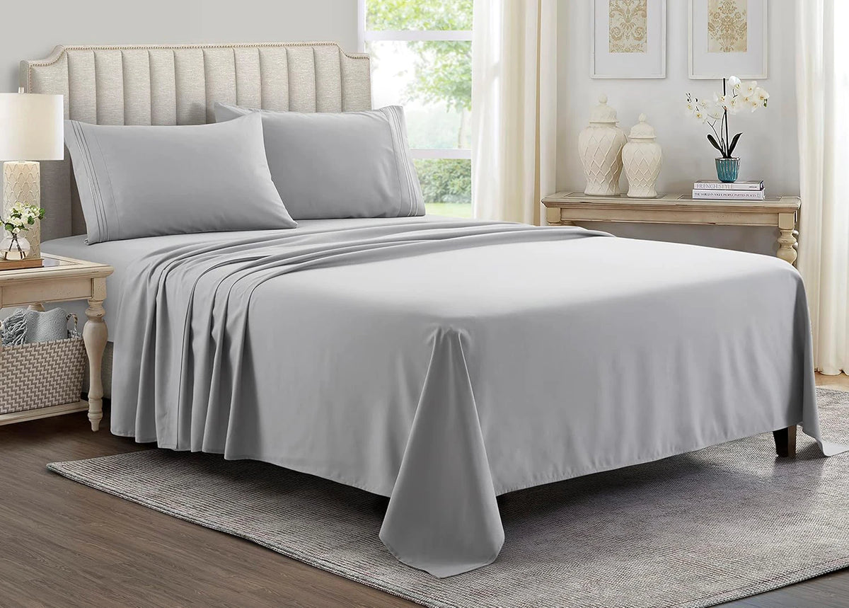 A gray luxury microfiber 4-piece bed sheet set with deep pockets displayed on a bed.