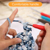 Hands are using a red precision aluminum crochet hook to work on a blue and white yarn craft.