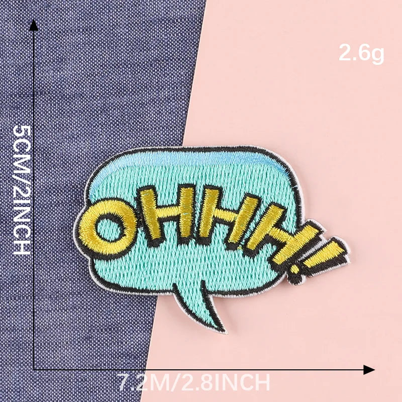 A teal embroidery patch with the text OHHH is shown against a dark blue fabric background.