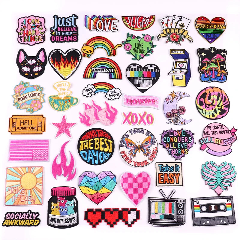 A collection of colorful embroidered letter patches featuring words like LOVE, JUST, and SUGAR for jackets and clothing.