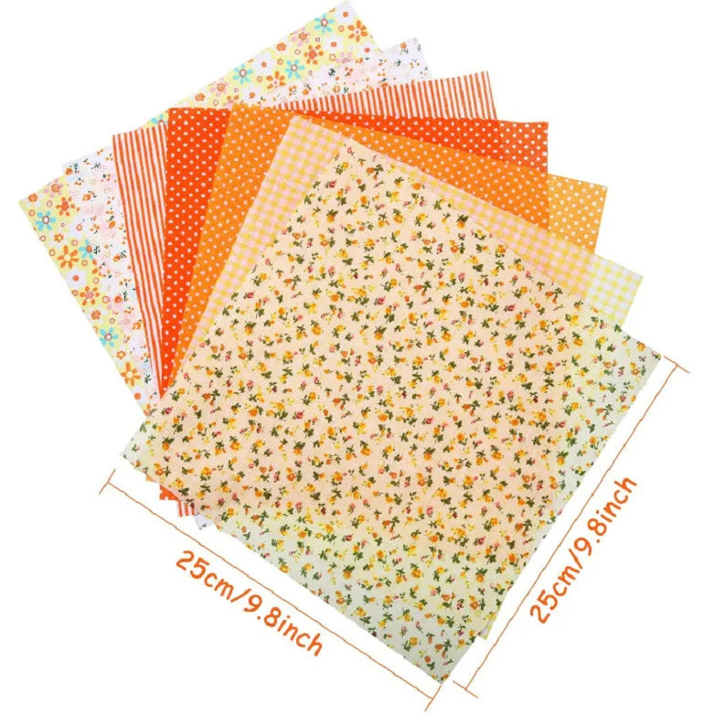 A stack of colorful floral dot pattern cotton fabric squares in various shades of orange, yellow, and pink.
