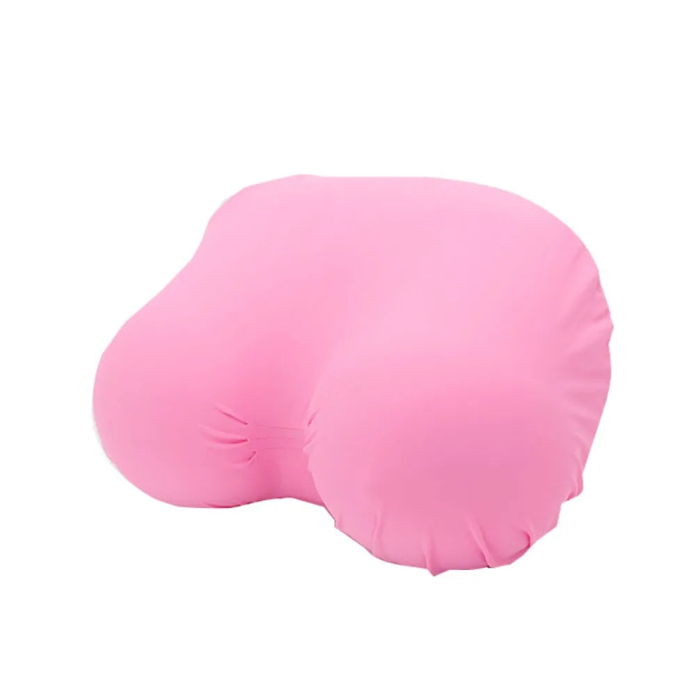 A pink memory foam contour chest pillow shown from the side.