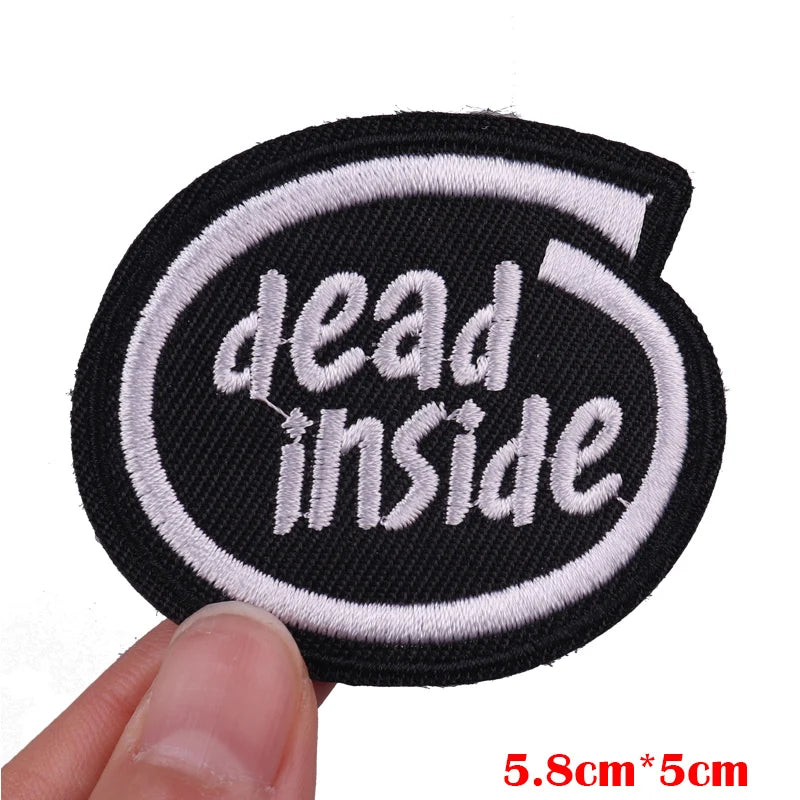 Black embroidered patch with white text reading dead inside