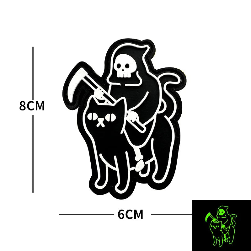 Black silhouette of a skull and cat with a dagger, designed as a glow-in-the-dark biker patch.
