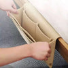 A hand is opening a felt bedside storage organizer with a hanging pocket, showing the interior structure.
