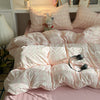 Pink plaid duvet cover set with matching pillowcases displayed on a bed.