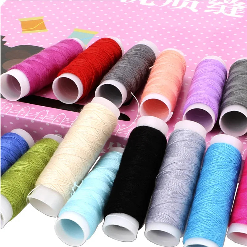 A collection of various colored industrial sewing thread spools arranged on a pink background.