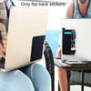 A laptop is shown open on a table next to a person, with flat back stickers visible.