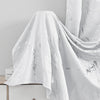 White marble printed curtain fabric draped elegantly against a light gray background.