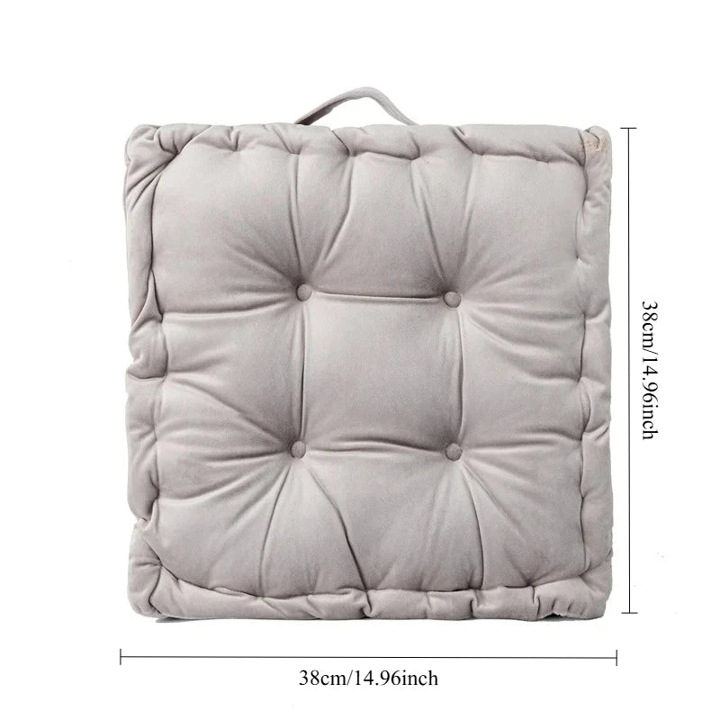 A square, light gray quilted cotton throw pillow with a handle, shown flat.