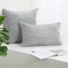 A gray corduroy striped throw pillow cover displayed on a white surface.