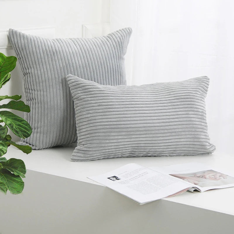 A gray corduroy striped throw pillow cover displayed on a white surface.