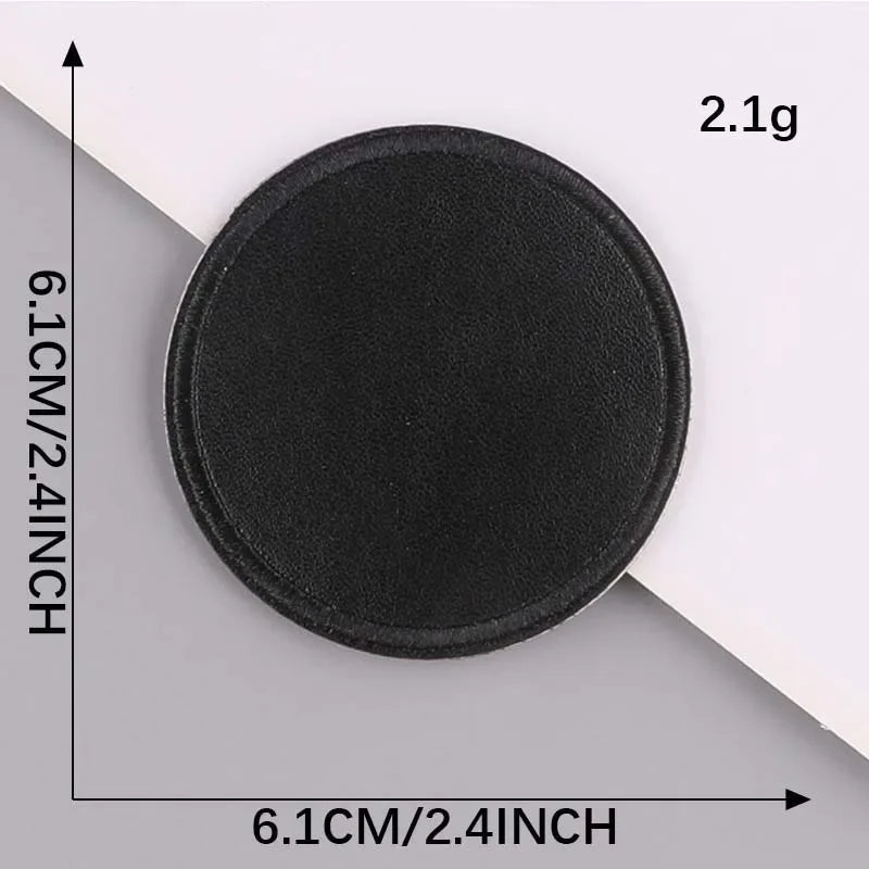 A round black embroidered leather patch with a self-adhesive backing, measuring 6.1cm by 2.4inch.