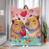 A pink flannel blanket featuring a cartoon print of two cute, fluffy brown rodents with hearts.