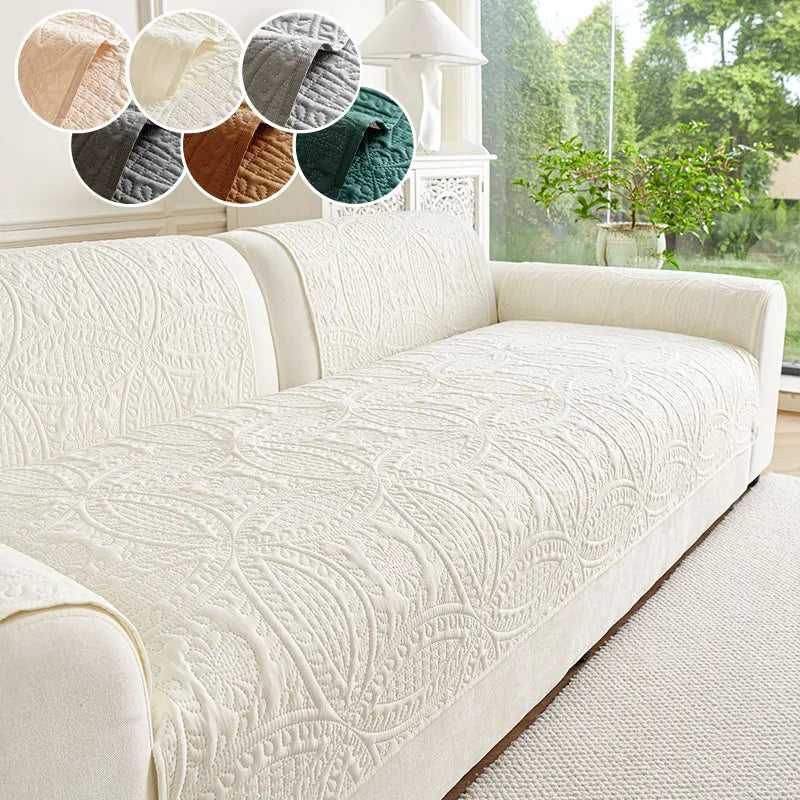 A cream textured sofa cushion displayed with various fabric swatches and a potted plant in a bright room.