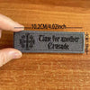 A dark gray embroidered patch featuring the text Time for another Crusade on a wooden surface.