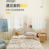 A simple style bedroom featuring a quilted blanket and light decor.
