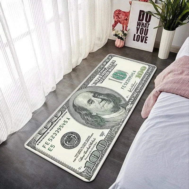 A folded US one dollar bill lying on a gray floor next to a white window and a pink plant.