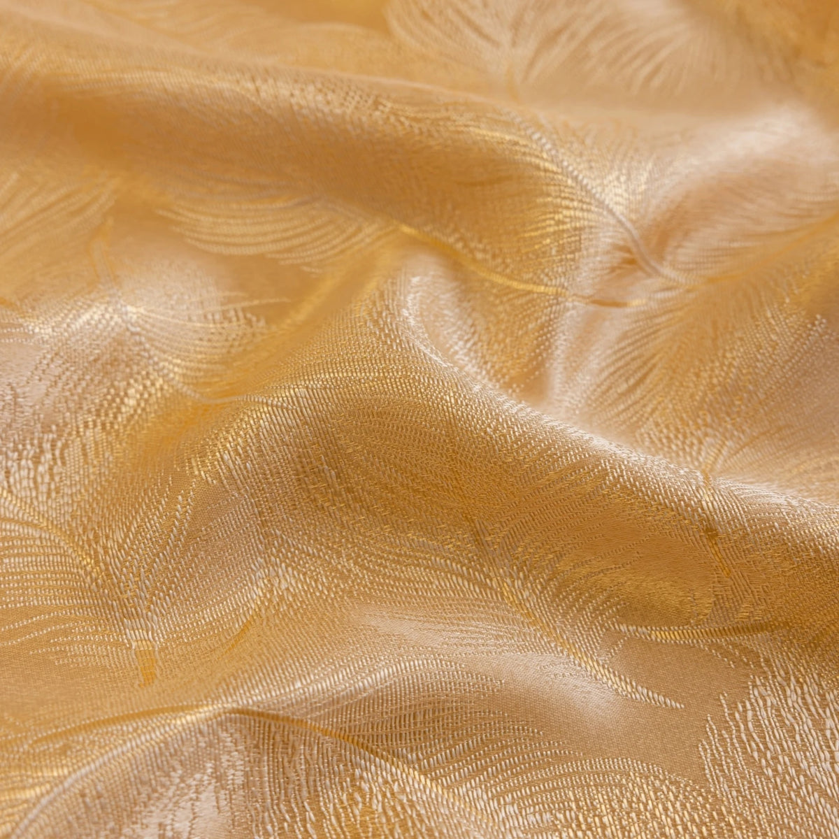 Close-up of luxurious gold blackout curtains featuring a feather jacquard fabric texture.