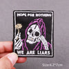 Black embroidered patch featuring a skull with hands and the text HOPE FOR NOTHING WE ARE LIARS