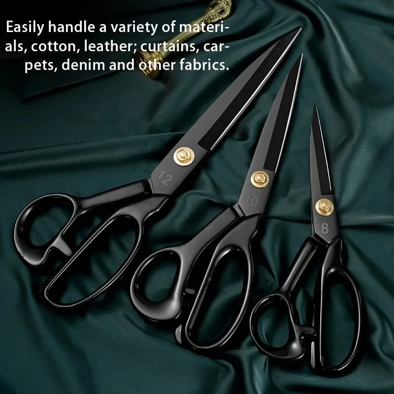 A set of heavy-duty carbon steel tailor scissors with black handles resting on a dark green fabric.