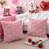 Pink heart embroidery plush cushion covers and a teddy bear on a white sofa