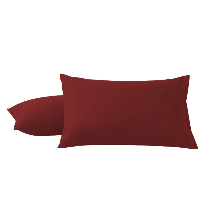 A pair of solid maroon microfiber pillow covers.