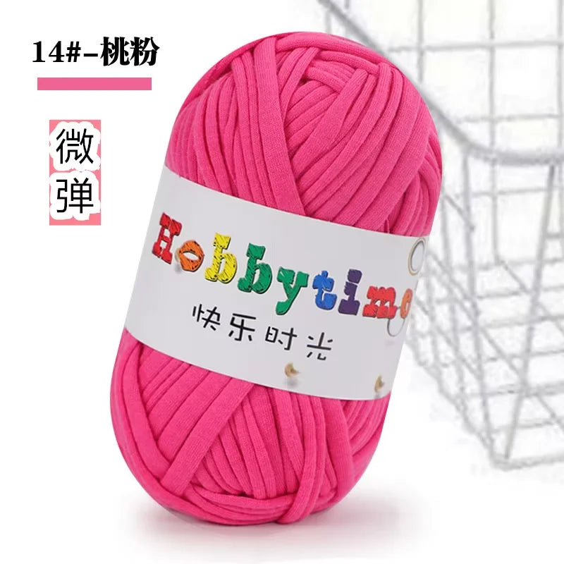 A ball of bright pink thick polyester craft yarn labeled Hobbytime for knitting and crochet