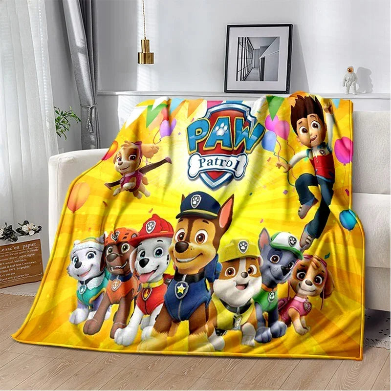 A colorful cartoon Paw Patrol themed flannel throw blanket featuring various animated dog characters.