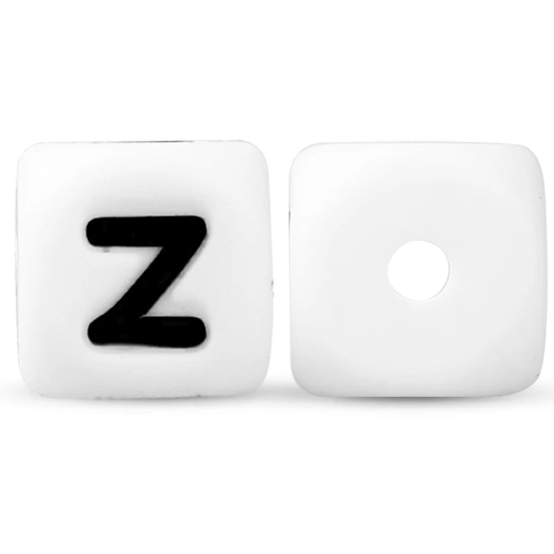 A white soft silicone alphabet bead shaped like the letter Z and another blank bead.