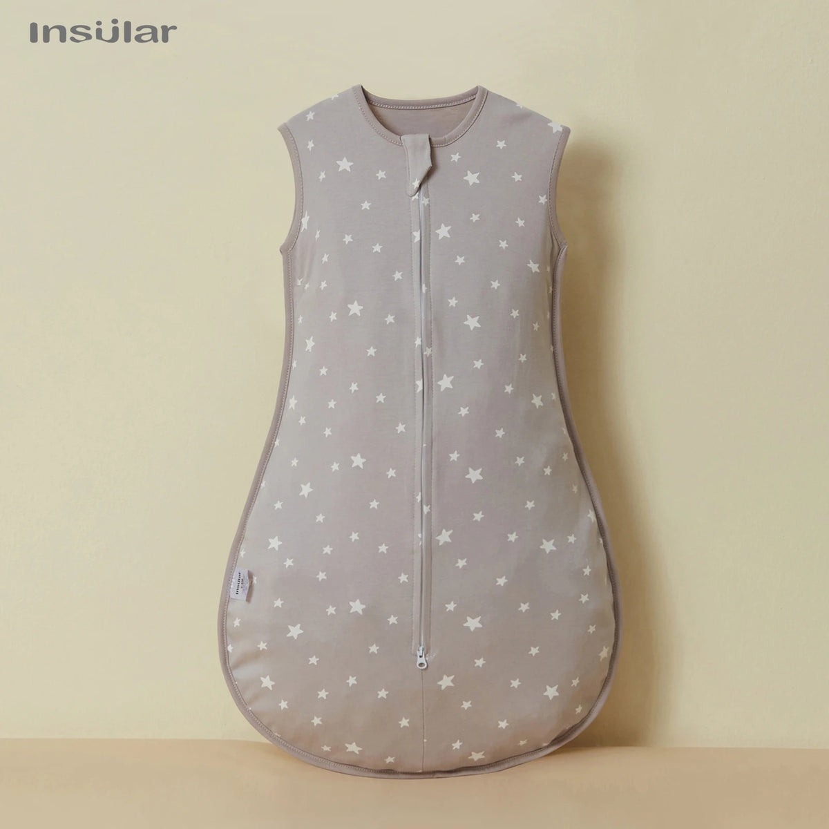 A light gray unisex cotton sleep sack for baby and toddler with a star pattern.