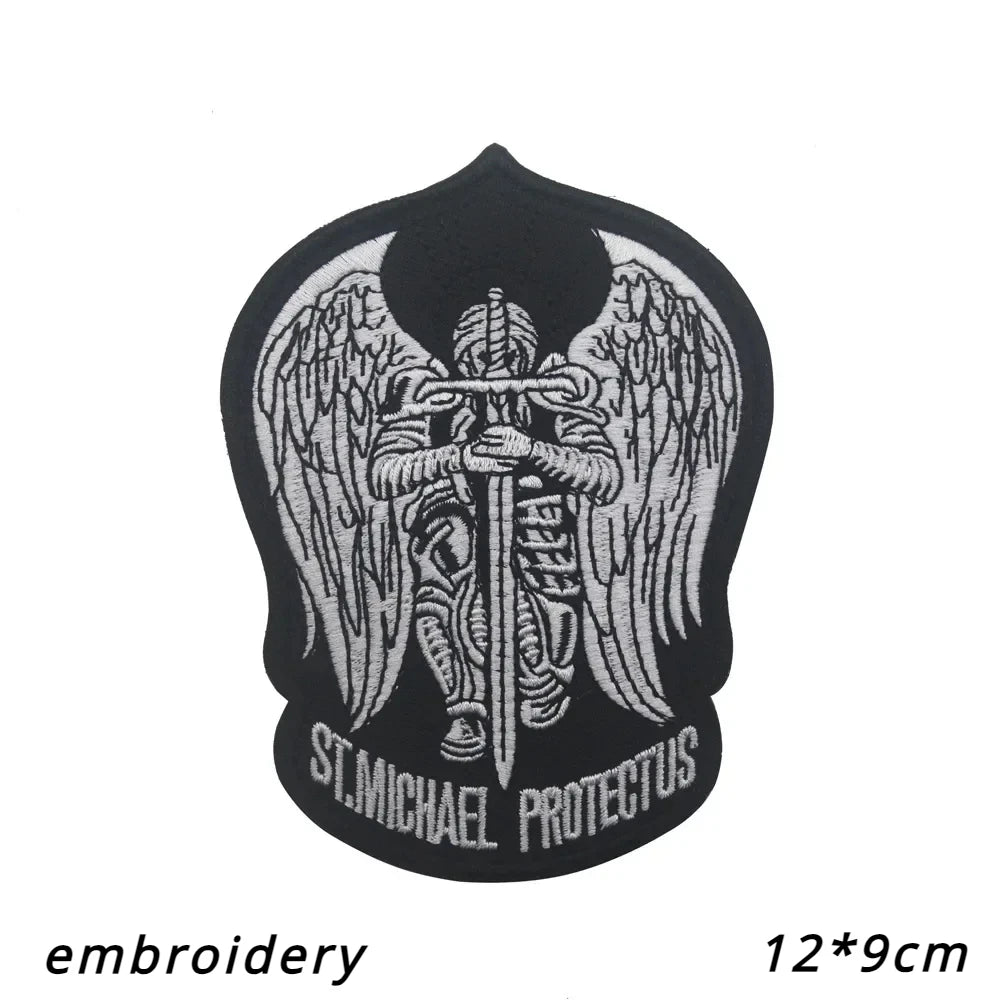 Black embroidered angel patch featuring a dove and wings with the text St. Michael Protectus