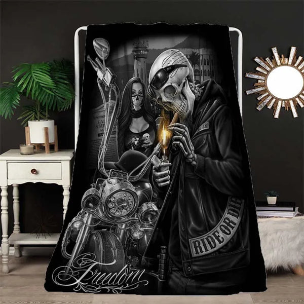 A dark flannel throw blanket featuring a graphic design of a motorcycle skull and gothic imagery.