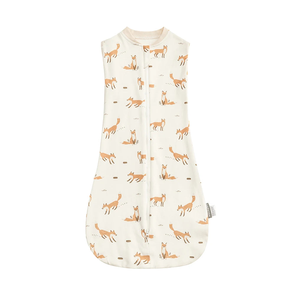 A cream-colored soft cotton baby sleeping bag featuring a repeating pattern of small orange and beige animal silhouettes.
