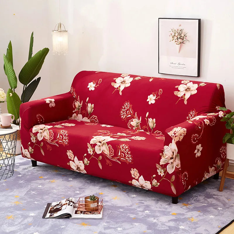 A deep red floral patterned sofa and chair slipcover displayed on a light purple rug.