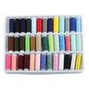 A white plastic tray filled with 39 different colors of industrial sewing thread spools.