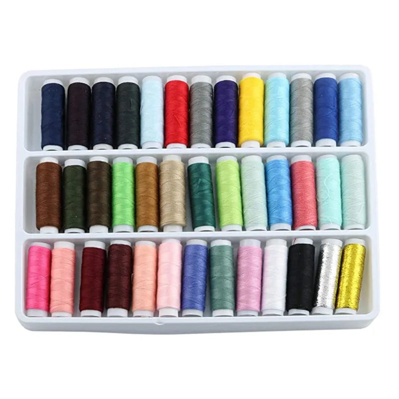 A white plastic tray filled with 39 different colors of industrial sewing thread spools.