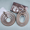 Set of round wooden embroidery hoops in various shades of brown and white for cross stitch