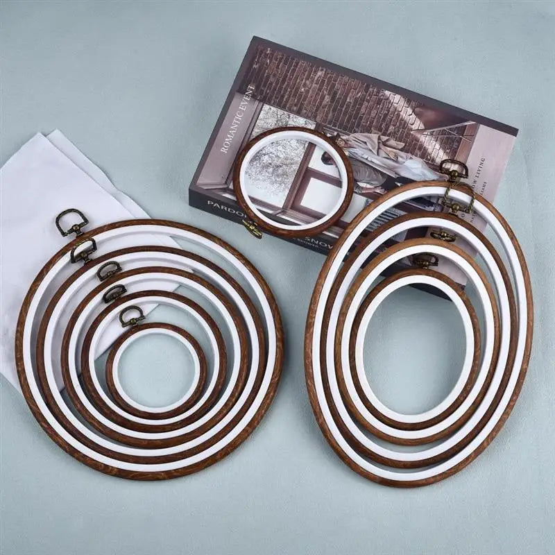 Set of round wooden embroidery hoops in various shades of brown and white for cross stitch