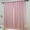 Pink double-layer blackout curtains with a sheer lace overlay hanging in a window.