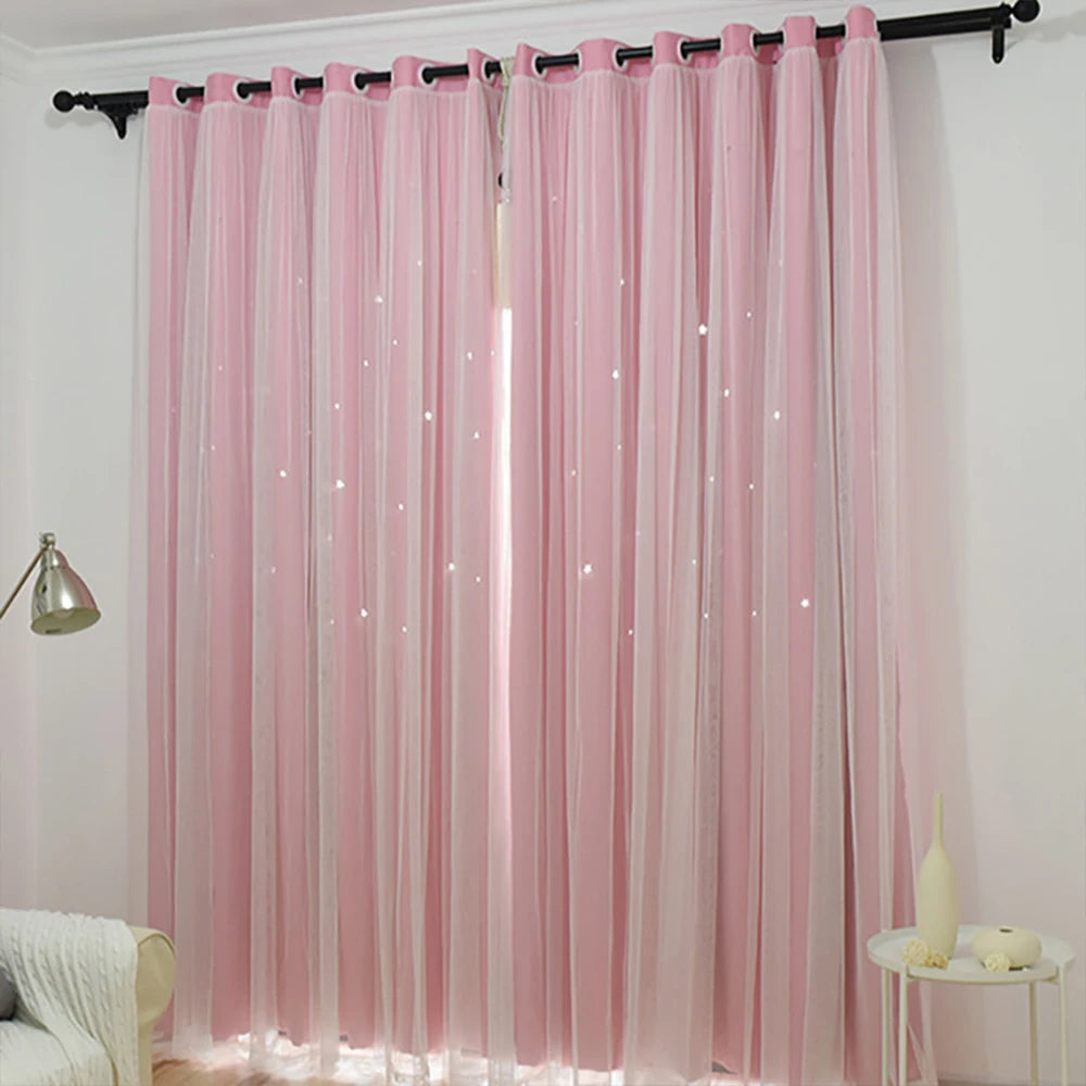 Pink double-layer blackout curtains with a sheer lace overlay hanging in a window.