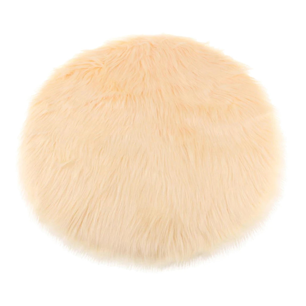 Round beige faux fur sheepskin area rug with a fluffy texture